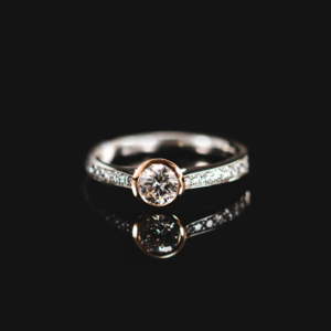 Platinum and 18ct rose gold diamond solitaire with diamond shoulders. Bespoke Jewellery, Knights Fine Jewellery - Stratford upon Avon
